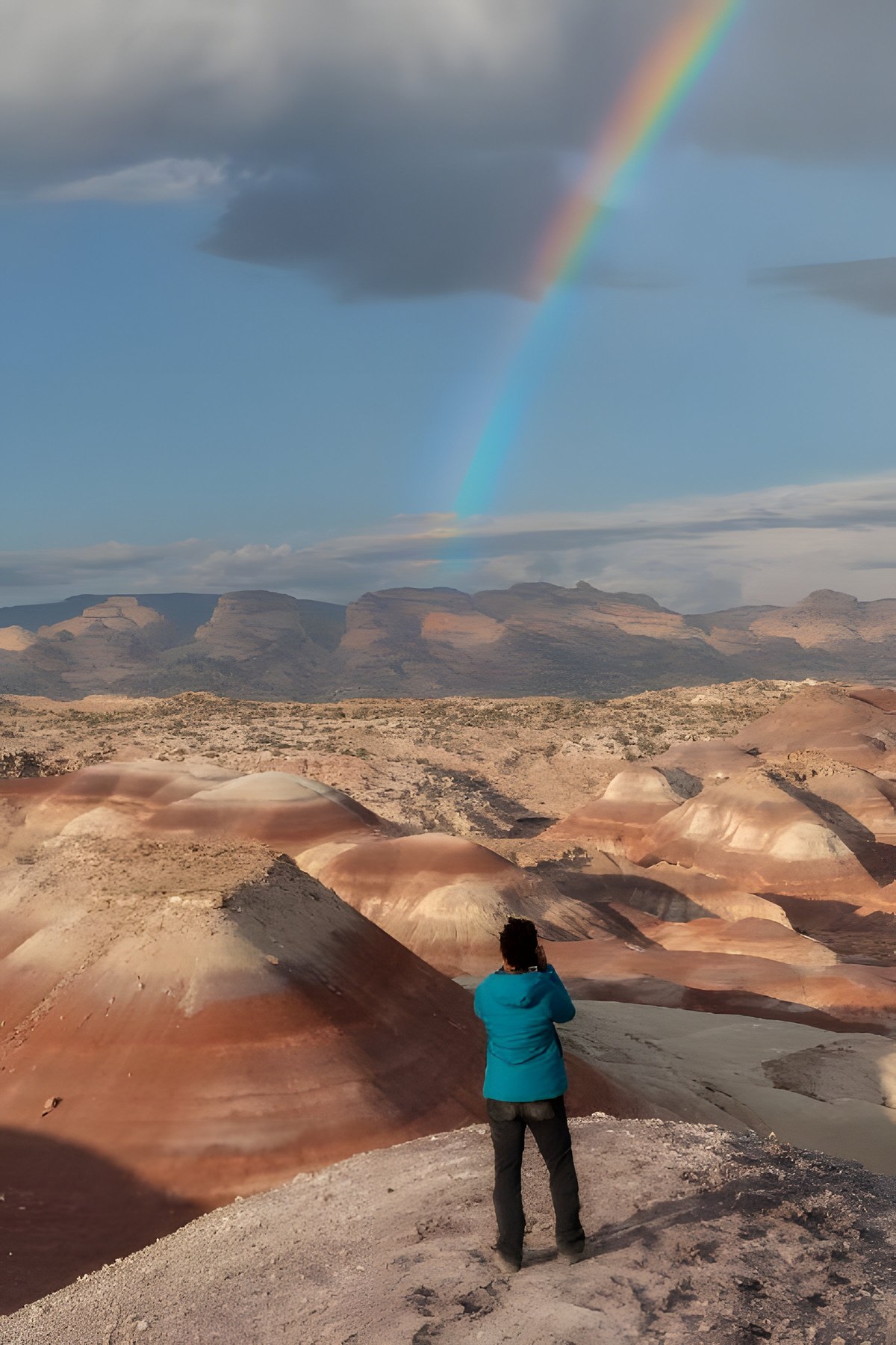 Tara photographing a rainbow over the painted badlands